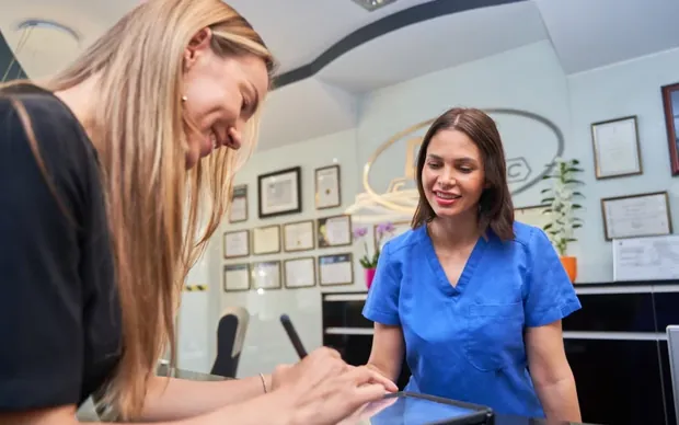 A patient completing a form on a tablet
