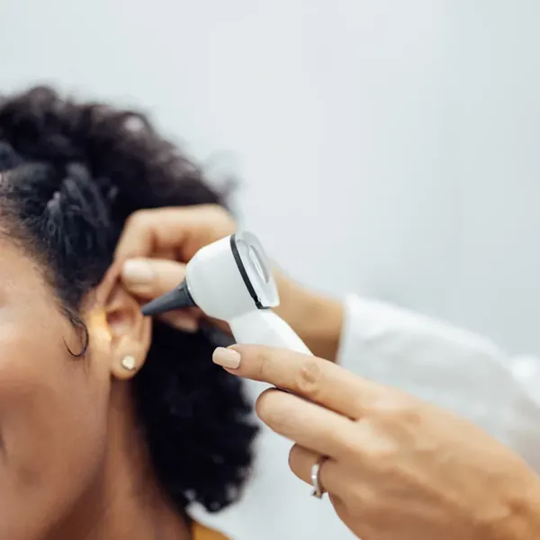 A doctor examining a patient&rsquo;s ear