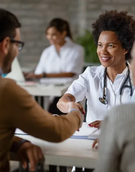 A doctor shaking hands with a patient