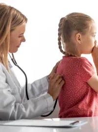 A pediatrician examining a child