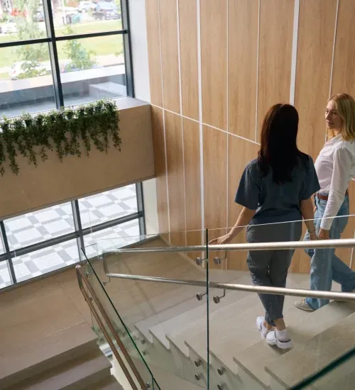 A patient talking with a physician on the stairs