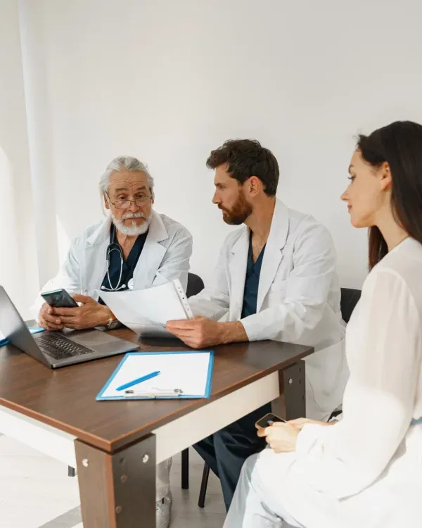 Two doctors consulting a patient