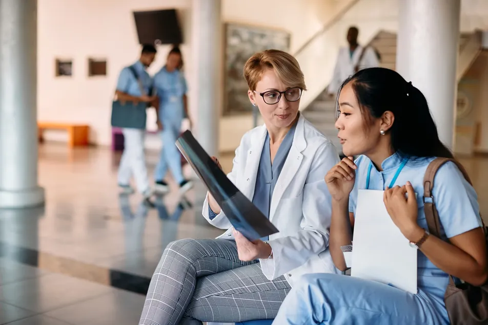 Two clinicians reviewing an X-ray together
